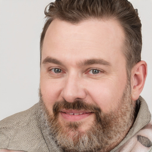 Joyful white adult male with short  brown hair and brown eyes