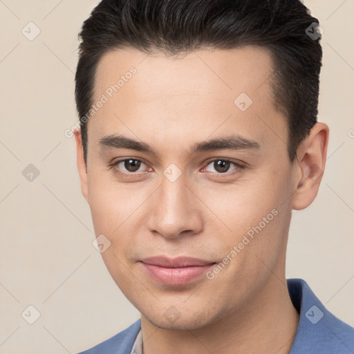 Joyful white young-adult male with short  brown hair and brown eyes