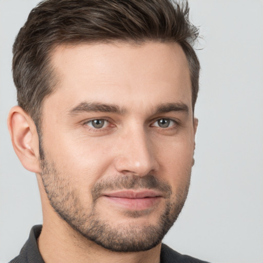 Joyful white young-adult male with short  brown hair and brown eyes