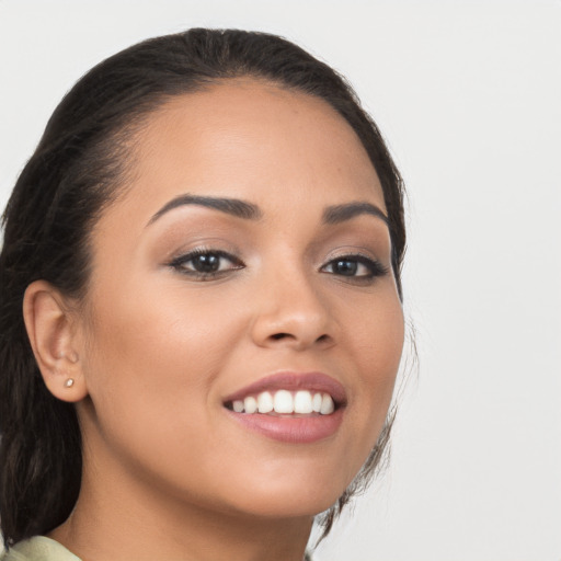 Joyful latino young-adult female with long  brown hair and brown eyes