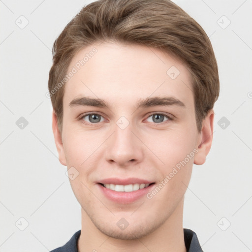 Joyful white young-adult male with short  brown hair and grey eyes