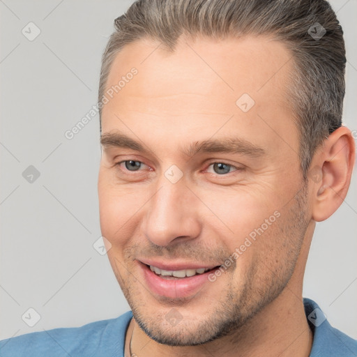 Joyful white adult male with short  brown hair and brown eyes