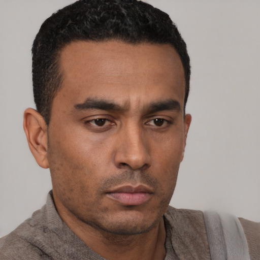 Neutral latino young-adult male with short  brown hair and brown eyes