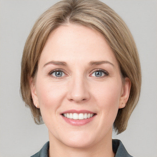 Joyful white young-adult female with medium  brown hair and blue eyes