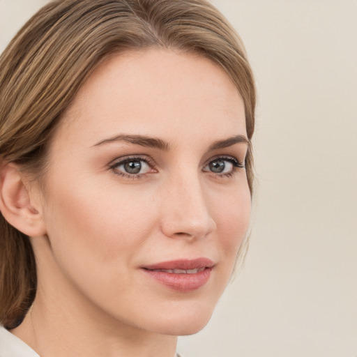 Joyful white young-adult female with medium  brown hair and green eyes