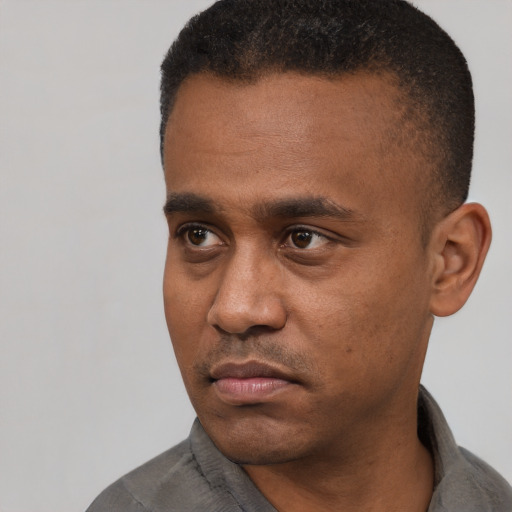 Neutral latino adult male with short  black hair and brown eyes