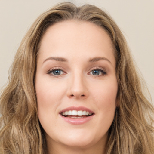 Joyful white young-adult female with long  brown hair and green eyes