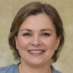 Joyful white adult female with medium  brown hair and brown eyes