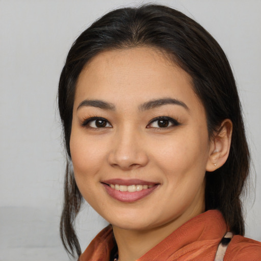 Joyful asian young-adult female with medium  brown hair and brown eyes