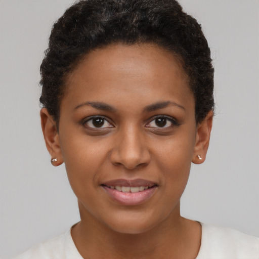 Joyful black young-adult female with short  brown hair and brown eyes