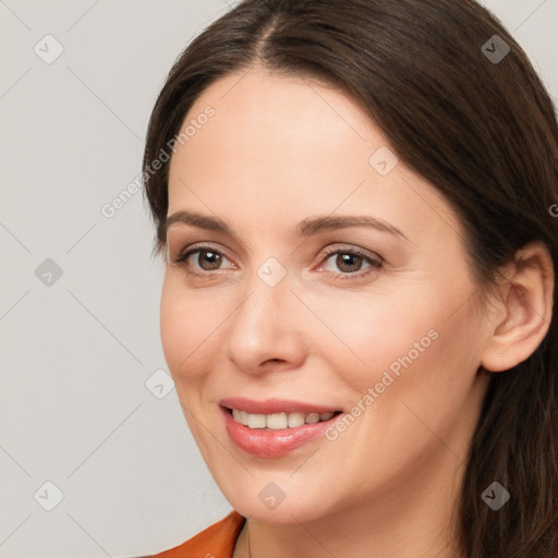 Joyful white young-adult female with long  brown hair and brown eyes