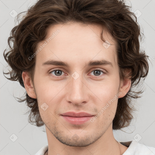 Joyful white young-adult male with medium  brown hair and brown eyes