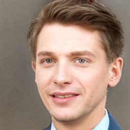 Joyful white young-adult male with short  brown hair and grey eyes