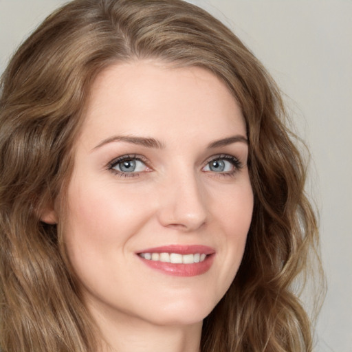 Joyful white young-adult female with long  brown hair and green eyes