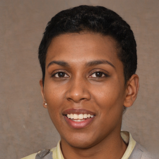 Joyful black young-adult female with short  black hair and brown eyes