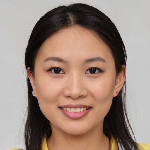 Joyful asian young-adult female with medium  brown hair and brown eyes