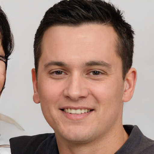 Joyful white young-adult male with short  brown hair and brown eyes