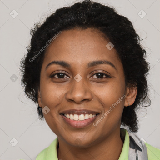 Joyful black young-adult female with long  brown hair and brown eyes