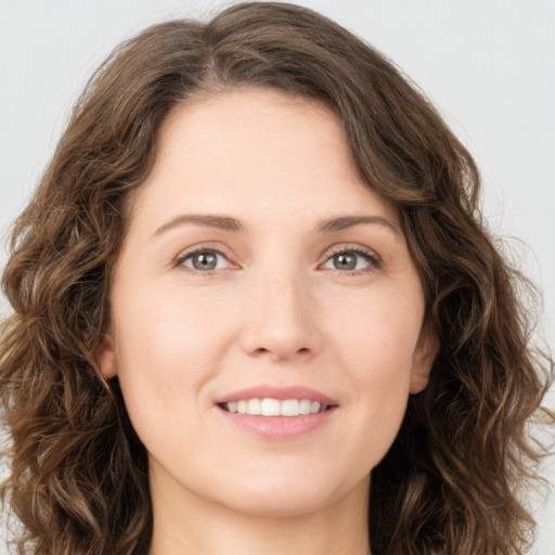 Joyful white young-adult female with long  brown hair and green eyes