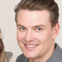 Joyful white adult male with medium  brown hair and brown eyes