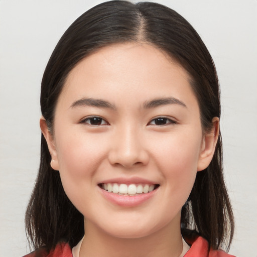 Joyful white young-adult female with long  brown hair and brown eyes