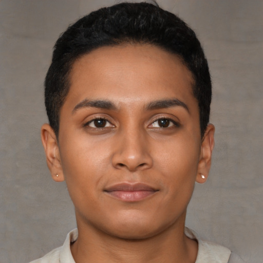 Joyful latino young-adult male with short  brown hair and brown eyes