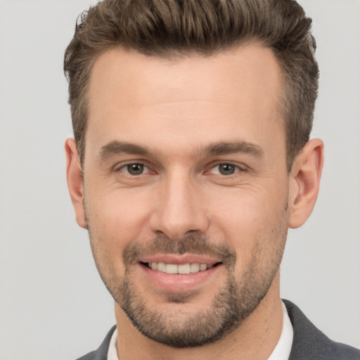 Joyful white adult male with short  brown hair and brown eyes