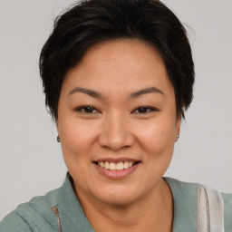 Joyful asian young-adult female with short  brown hair and brown eyes