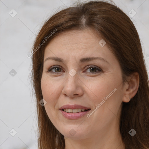 Joyful white adult female with long  brown hair and brown eyes