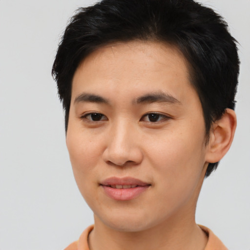 Joyful asian young-adult male with short  brown hair and brown eyes