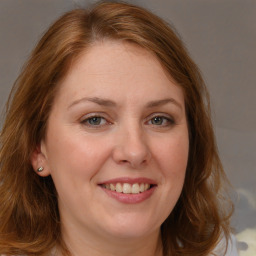 Joyful white adult female with long  brown hair and brown eyes