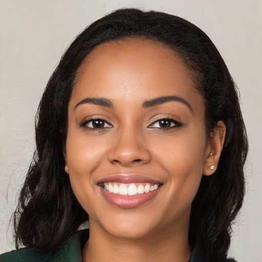 Joyful latino young-adult female with long  black hair and brown eyes