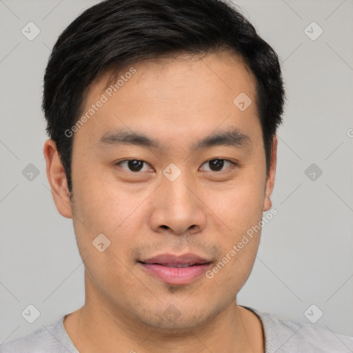 Joyful asian young-adult male with short  brown hair and brown eyes