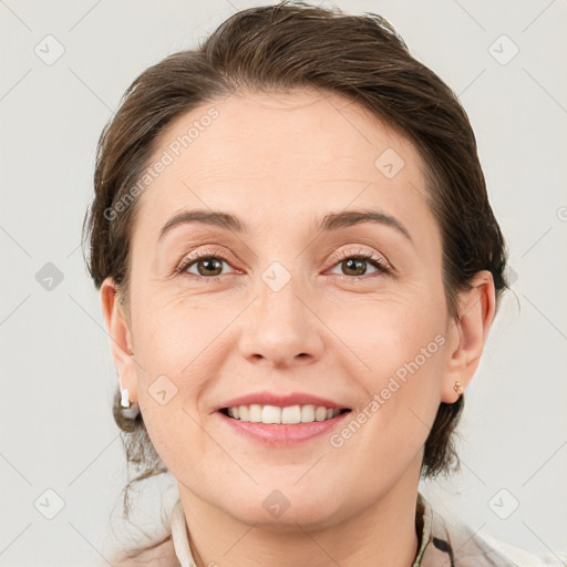 Joyful white young-adult female with medium  brown hair and grey eyes