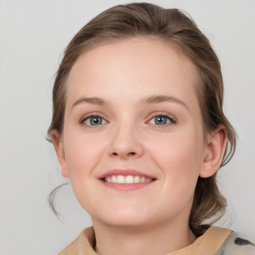 Joyful white young-adult female with medium  brown hair and blue eyes