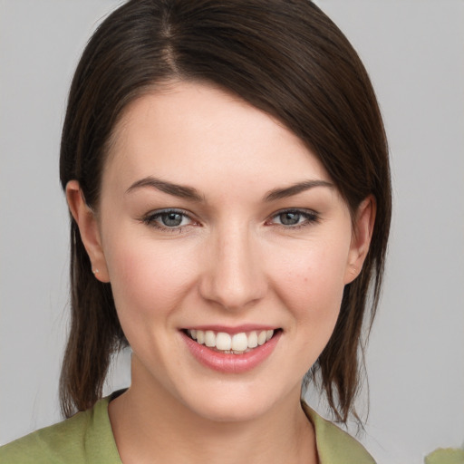 Joyful white young-adult female with medium  brown hair and brown eyes