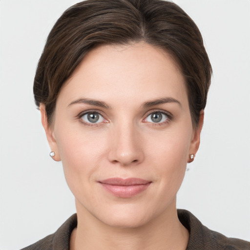 Joyful white young-adult female with short  brown hair and grey eyes