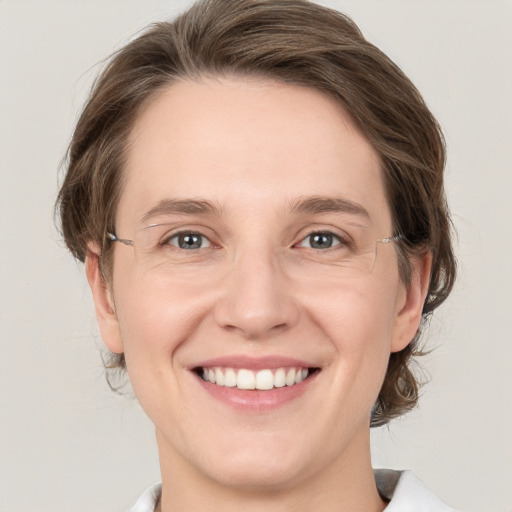 Joyful white young-adult female with medium  brown hair and grey eyes