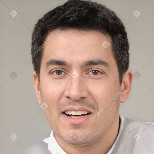 Joyful white adult male with short  black hair and brown eyes