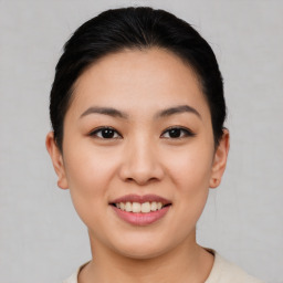 Joyful asian young-adult female with short  brown hair and brown eyes