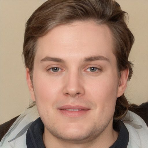 Joyful white young-adult male with medium  brown hair and brown eyes