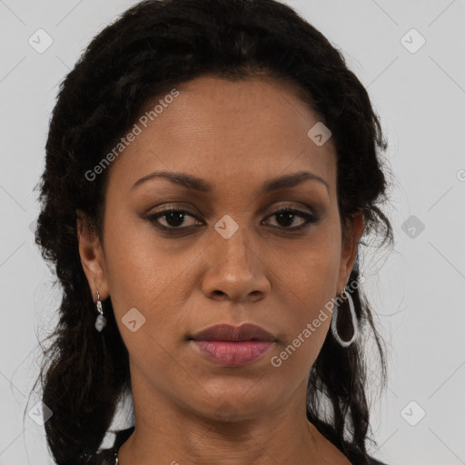 Joyful black adult female with medium  brown hair and brown eyes