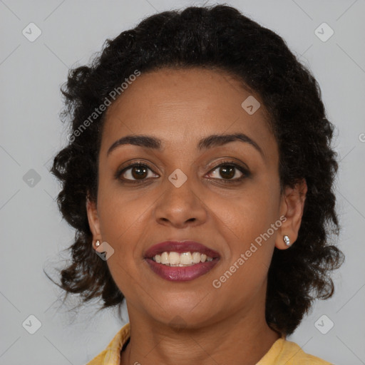 Joyful black young-adult female with long  brown hair and brown eyes