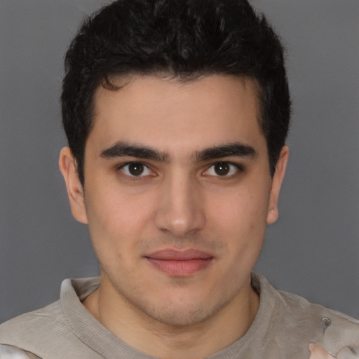 Joyful latino young-adult male with short  brown hair and brown eyes