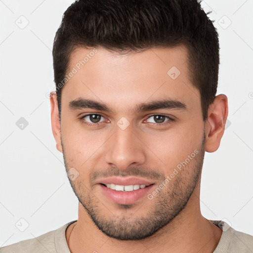 Joyful white young-adult male with short  brown hair and brown eyes