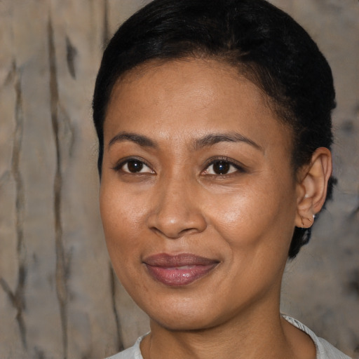 Joyful black adult female with short  brown hair and brown eyes