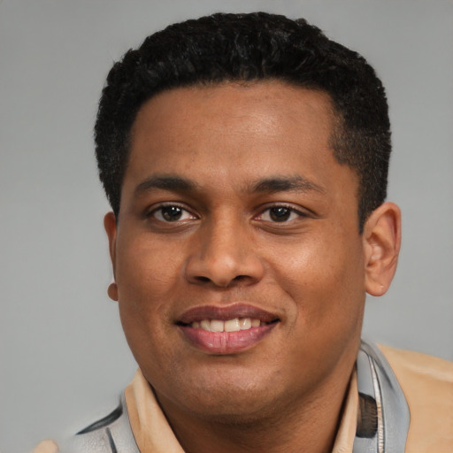 Joyful latino young-adult male with short  black hair and brown eyes