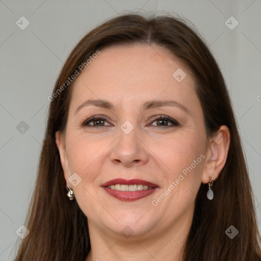 Joyful white adult female with long  brown hair and grey eyes