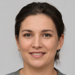 Joyful white young-adult female with medium  brown hair and brown eyes