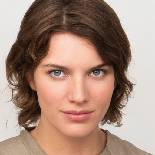 Joyful white young-adult female with medium  brown hair and green eyes